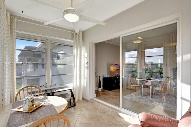 sunroom featuring ceiling fan