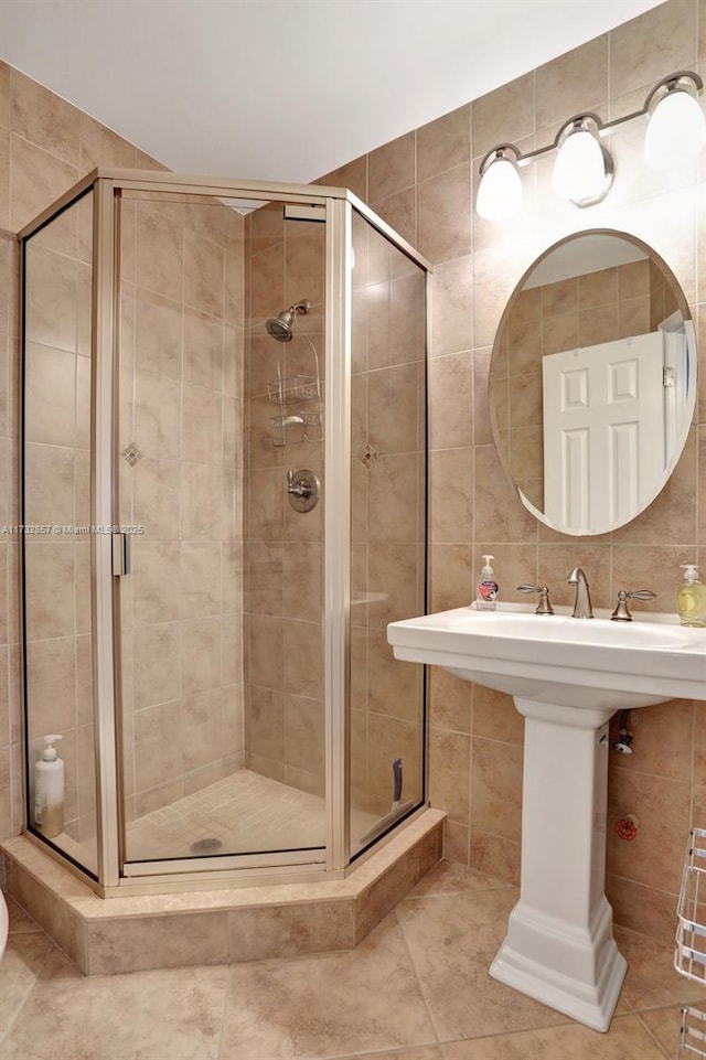 bathroom with tile walls and an enclosed shower