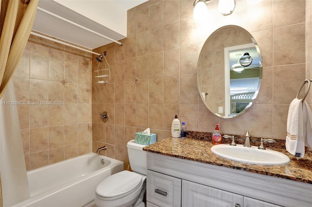 full bathroom with vanity, tile walls, shower / bathtub combination with curtain, and toilet