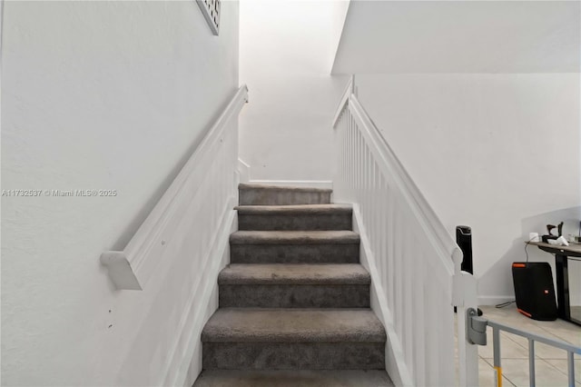 staircase with tile patterned floors