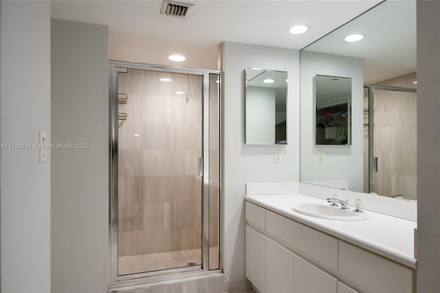 bathroom with vanity and a shower with shower door