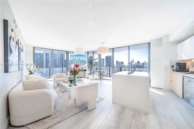 living room featuring light hardwood / wood-style flooring and a wall of windows