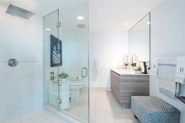 bathroom with tile patterned floors, vanity, toilet, and a shower with door