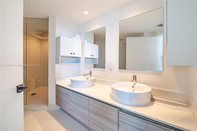 bathroom with walk in shower, tile patterned floors, and vanity