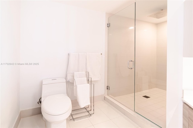 bathroom with a shower with door, tile patterned flooring, and toilet