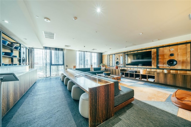 interior space featuring floor to ceiling windows and carpet