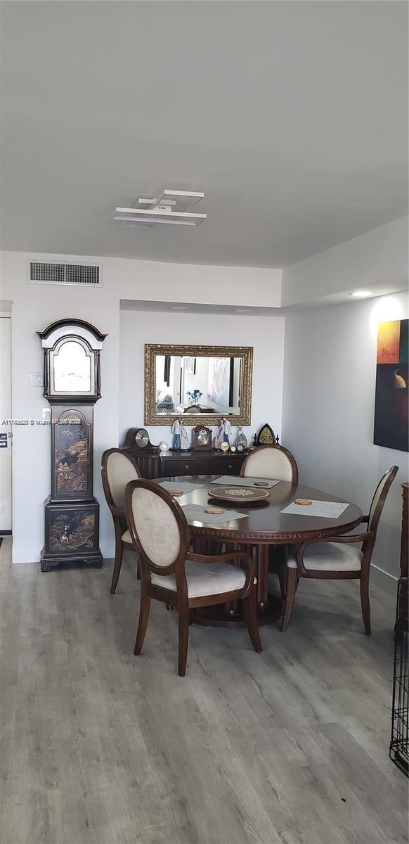 dining space with hardwood / wood-style flooring