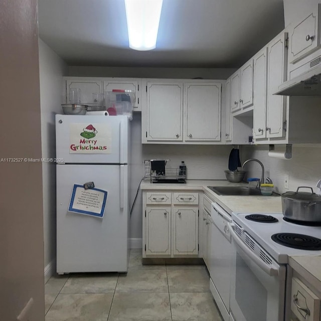 kitchen featuring sink, white appliances, light tile patterned floors, and white cabinets