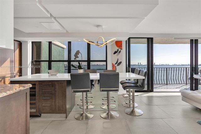 dining space featuring floor to ceiling windows and a notable chandelier