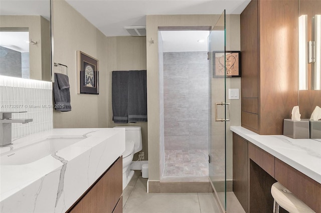 bathroom featuring vanity, tile patterned flooring, a shower with shower door, and toilet