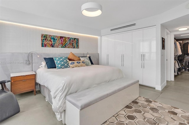 bedroom featuring concrete floors and a closet