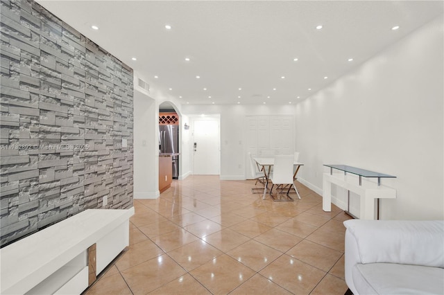 hall featuring light tile patterned flooring