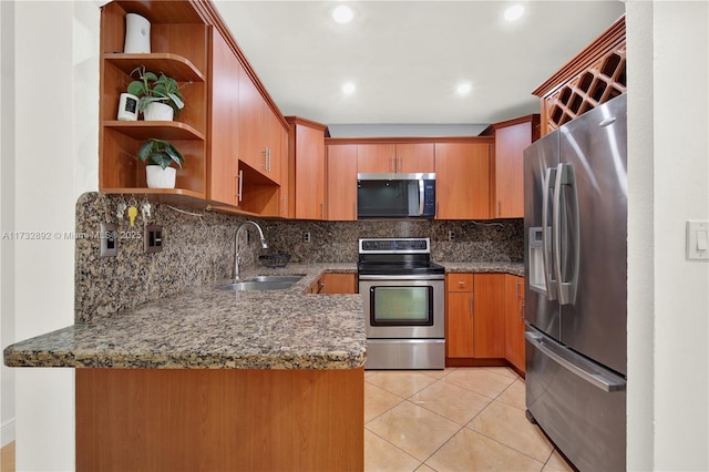 kitchen with sink, appliances with stainless steel finishes, dark stone countertops, light tile patterned flooring, and decorative backsplash