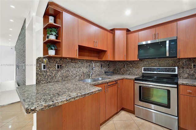 kitchen with sink, light tile patterned floors, appliances with stainless steel finishes, stone countertops, and kitchen peninsula