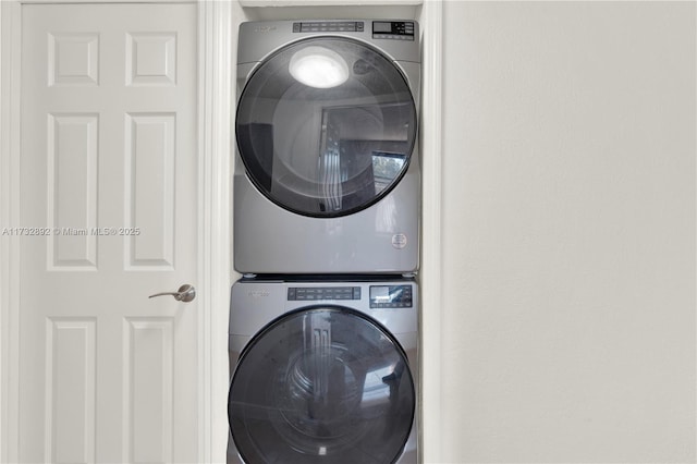 clothes washing area featuring stacked washing maching and dryer