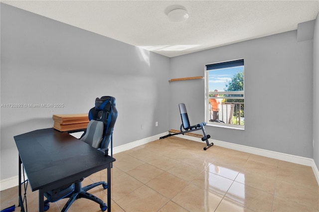 office with light tile patterned floors and a textured ceiling