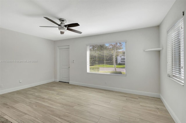 spare room featuring light hardwood / wood-style flooring and ceiling fan