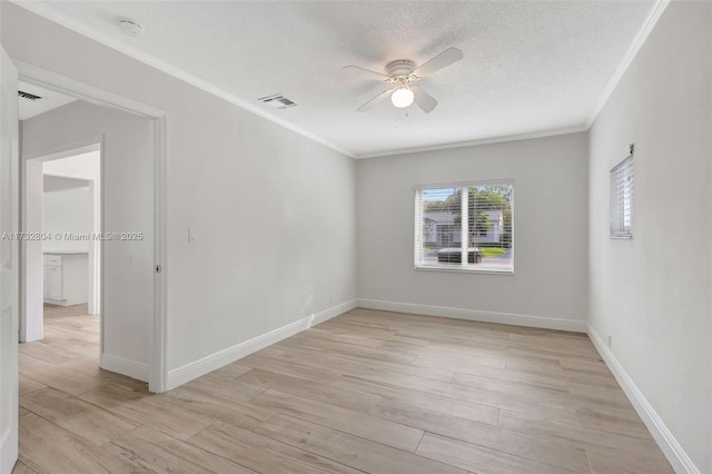 unfurnished room with ornamental molding, light hardwood / wood-style floors, and a textured ceiling