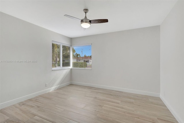 empty room with ceiling fan and light wood-type flooring