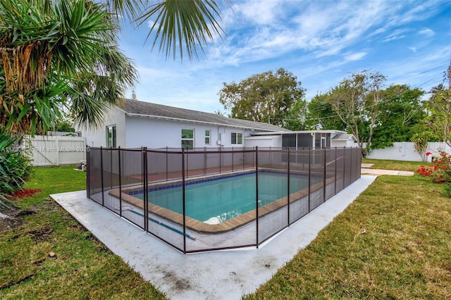 view of swimming pool with a lawn