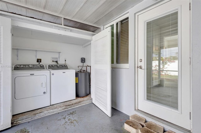 clothes washing area featuring water heater and independent washer and dryer