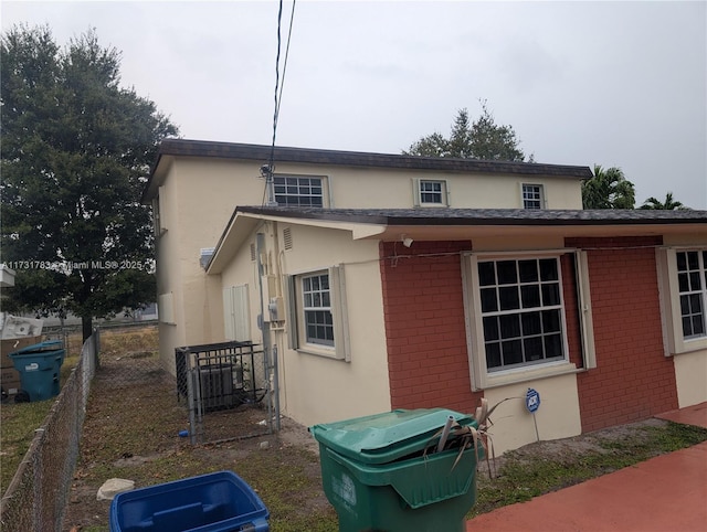 back of property featuring central AC unit