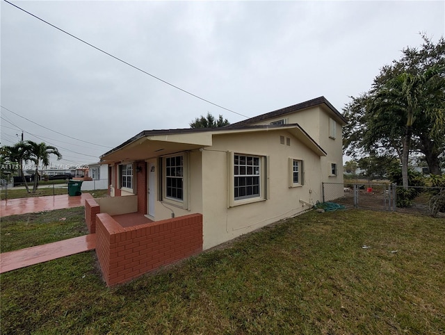 view of property exterior with a yard