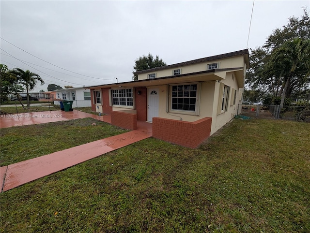 view of front of property with a patio and a front yard