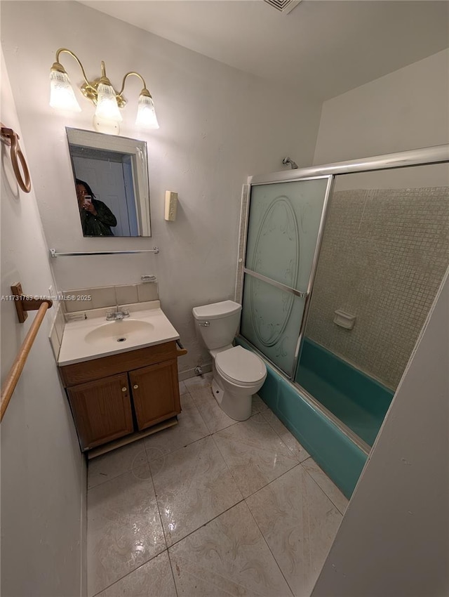 full bathroom with enclosed tub / shower combo, vanity, toilet, and tile patterned floors