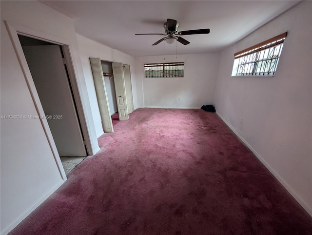 spare room featuring light carpet and ceiling fan