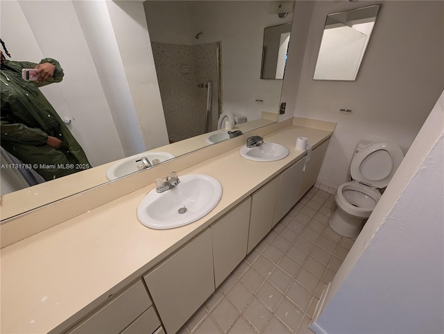 bathroom with vanity, tile patterned flooring, a shower, and toilet