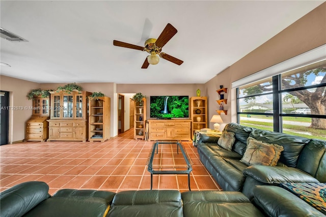 tiled living room featuring ceiling fan