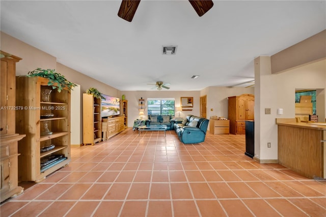 unfurnished living room with light tile patterned flooring and ceiling fan