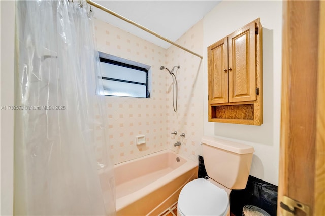 bathroom featuring toilet and shower / bath combo