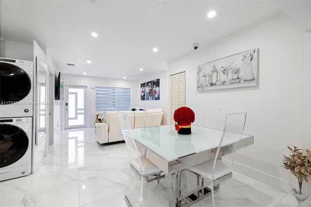 dining space with stacked washer and clothes dryer