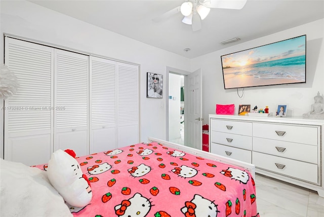 bedroom with ceiling fan and a closet