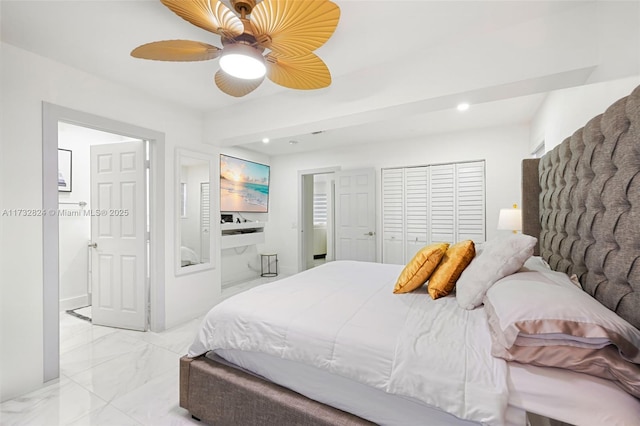 bedroom featuring ceiling fan and ensuite bathroom