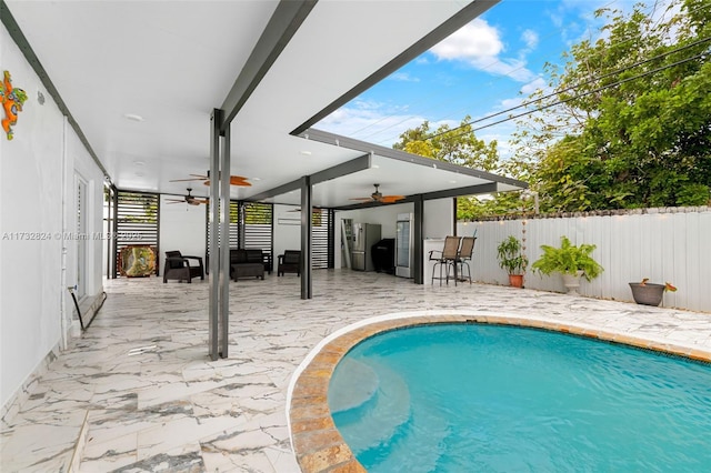 view of pool featuring a patio area and ceiling fan