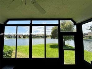 unfurnished sunroom featuring a water view and a wealth of natural light