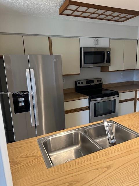 kitchen with sink and appliances with stainless steel finishes