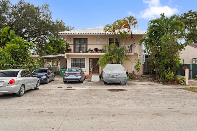 view of front of home featuring a carport and a balcony