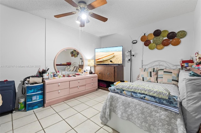 bedroom featuring light tile patterned floors, a textured ceiling, and ceiling fan