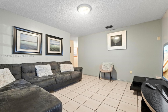 tiled living room with a textured ceiling