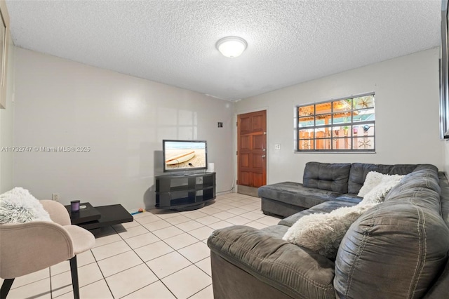 living room featuring light tile patterned flooring and a textured ceiling