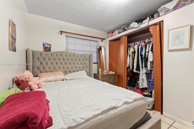 bedroom with light tile patterned flooring, a closet, and a textured ceiling