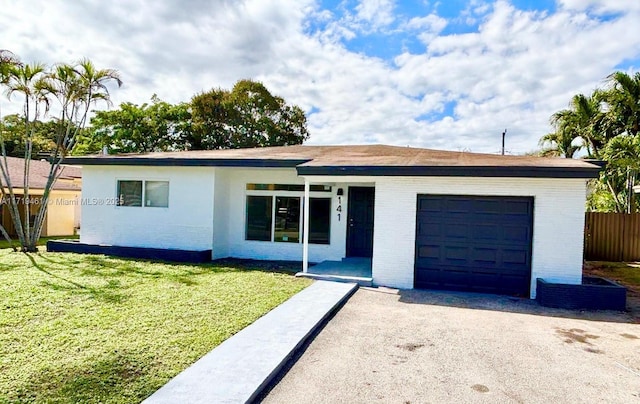 ranch-style house with a garage and a front lawn