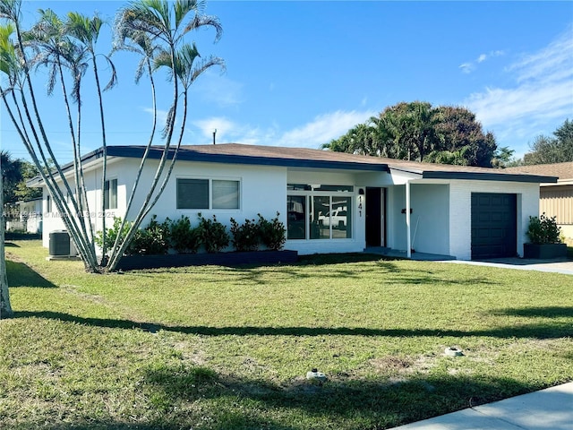 single story home with a garage and a front lawn