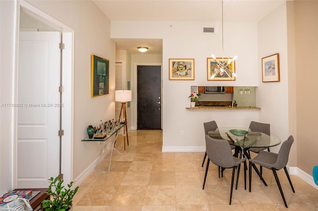 dining space with an inviting chandelier