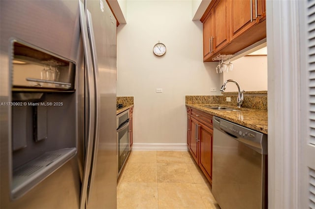 kitchen featuring stainless steel appliances, sink, and stone counters