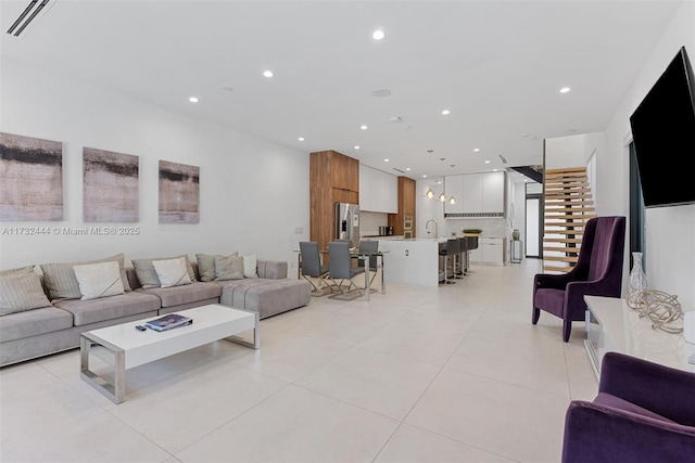 living room with sink and light tile patterned flooring